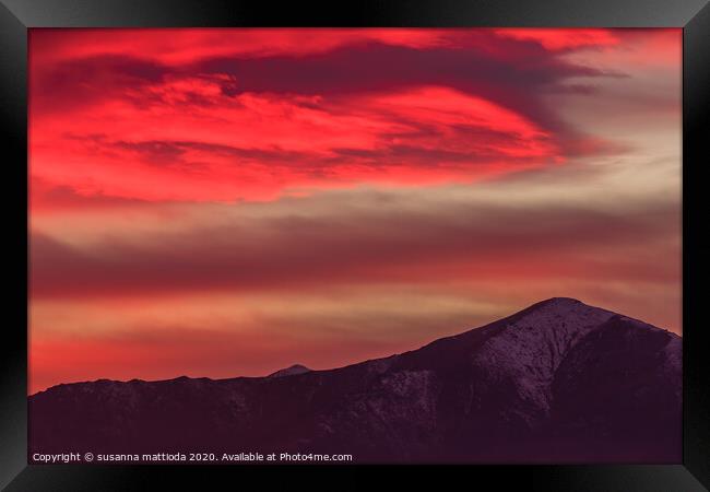 a spectacular red cloud above the mountains Framed Print by susanna mattioda