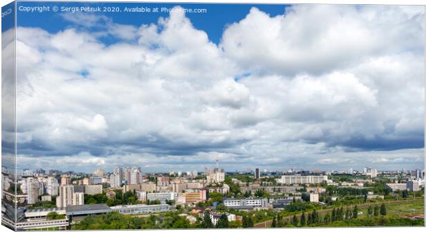 Panorama of Kyiv, with high cloudy skies over residential areas, green parks and a TV tower. Canvas Print by Sergii Petruk