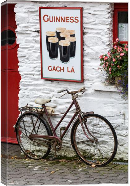 Old Guinness ad and Bicycle, West Cork, Ireland Canvas Print by Phil Crean