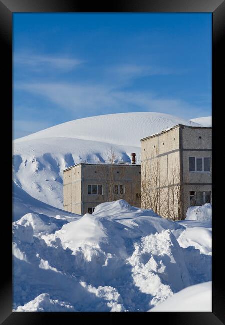 Snow-covered houses beyond the Arctic Circle in winter Framed Print by Tartalja 