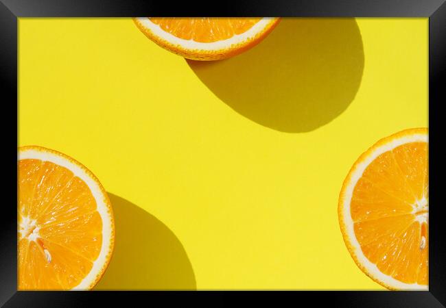 Oranges on yellow background Framed Print by Tartalja 