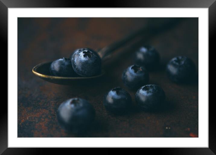 Fresh blueberry in a teaspoon on a rough surface Framed Mounted Print by Tartalja 