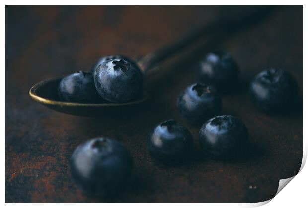 Fresh blueberry in a teaspoon on a rough surface Print by Tartalja 