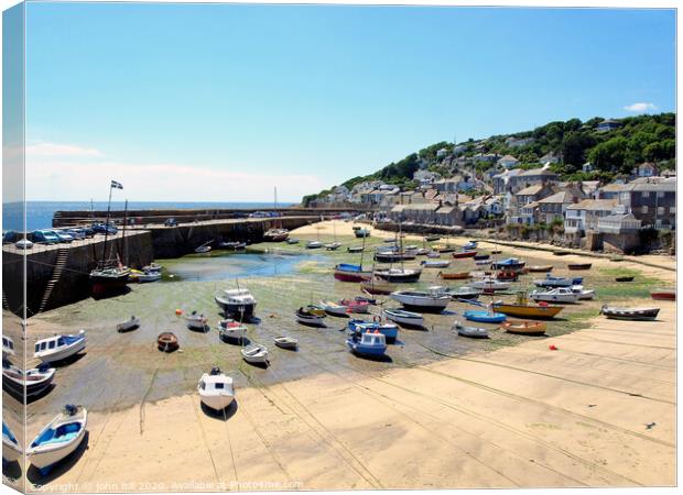 Mousehole harbour at low tide in Cornwall. Canvas Print by john hill