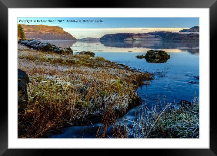 A wee burn flows into Loch Portree on the high tide. Framed Mounted Print by Richard Smith
