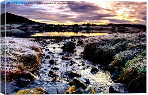 A burn flowing into Loch Portree on a freezing December day. Canvas Print by Richard Smith