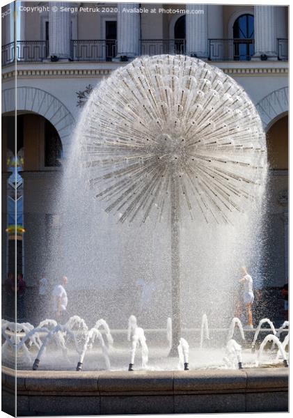 A beautiful city fountain in the shape of a huge dandelion refreshes passers-by against the background of the arched-column facade of the Kyiv City Conservatory. Canvas Print by Sergii Petruk