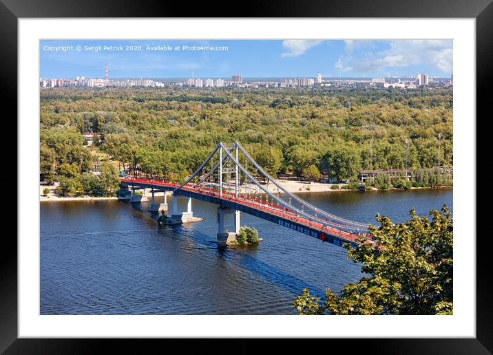 Pedestrian park bridge over the Dnipro river in Kyiv on a sunny summer day. Framed Mounted Print by Sergii Petruk