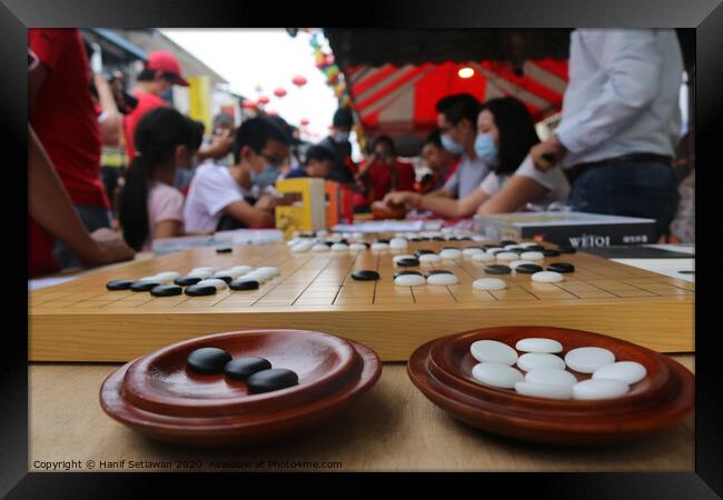 Chinese playing Go Game, Weiqi in a street. Framed Print by Hanif Setiawan
