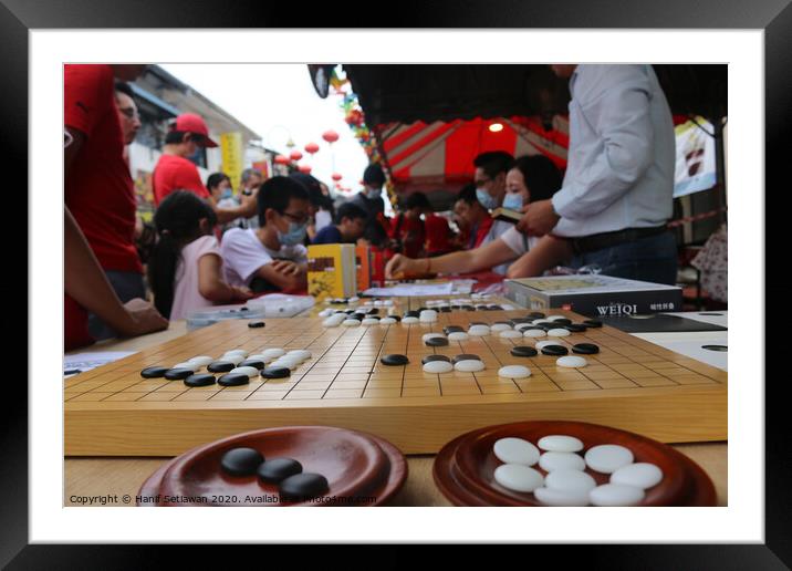 Chinese playing Go Game, Weiqi in a street. Framed Mounted Print by Hanif Setiawan