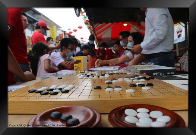 Chinese playing Go Game, Weiqi in a street. Framed Print by Hanif Setiawan