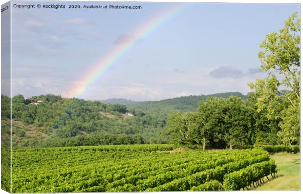 rainbow over vineyards in france Canvas Print by Rocklights 