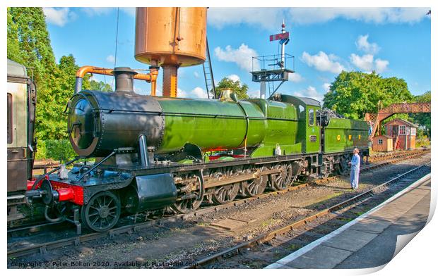 A steam locomotive takes on water at Buckfastleigh Station, Devon, UK. Print by Peter Bolton