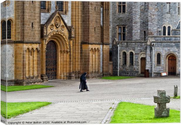 A nun crosses the courtyard at Buckfast Abbey, Dev Canvas Print by Peter Bolton