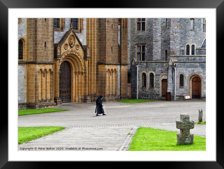 A nun crosses the courtyard at Buckfast Abbey, Dev Framed Mounted Print by Peter Bolton