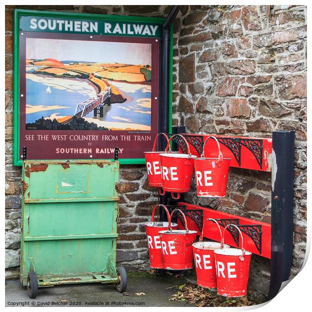Fire bucket at Southern railway station Print by David Belcher