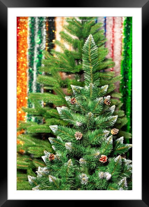Artificial Christmas pine on a background of multicolored tinsel in blur. Framed Mounted Print by Sergii Petruk