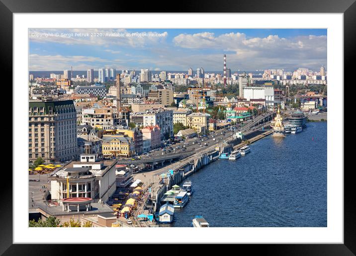 The landscape of summer Kyiv with a view of the Dnipro embankment in the old Podol district, piers and pleasure boats. Framed Mounted Print by Sergii Petruk