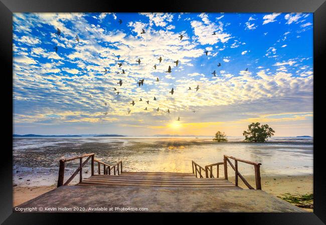 Sunrise with sunrays and flock of birds Framed Print by Kevin Hellon