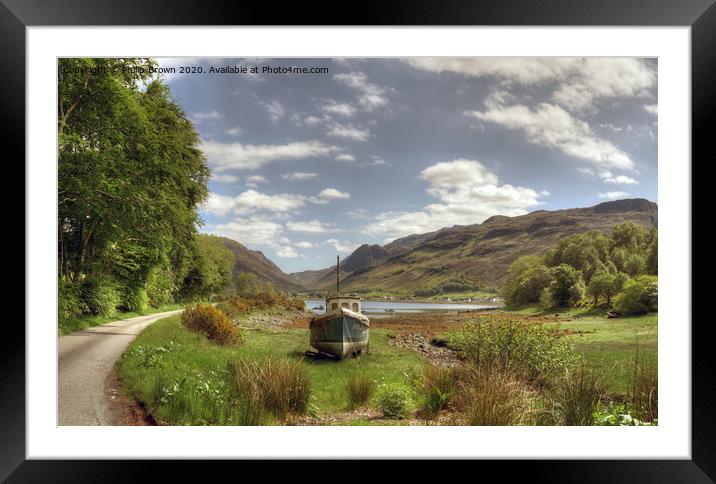 Boat near mountain road and lake in Scotland Framed Mounted Print by Philip Brown