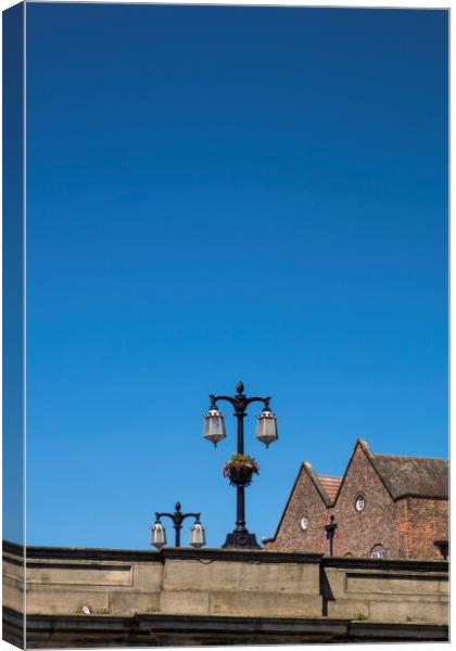 Street lamps against blue sky, York, Yorkshire,  Canvas Print by Phil Crean