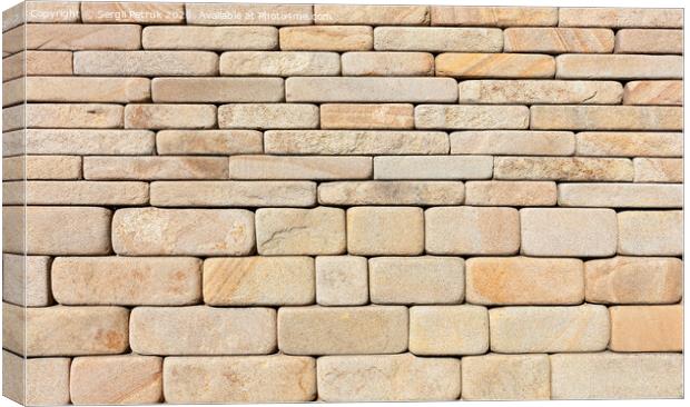 The wall is lined with hewn rounded yellow sandstone stone. Canvas Print by Sergii Petruk