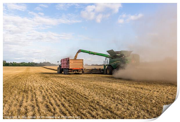 Combine harvester drains its grain in a tractor Print by Stig Alenäs