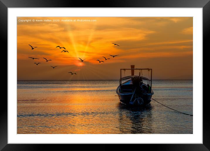 Boat facing the sunset in Pak Meng Framed Mounted Print by Kevin Hellon