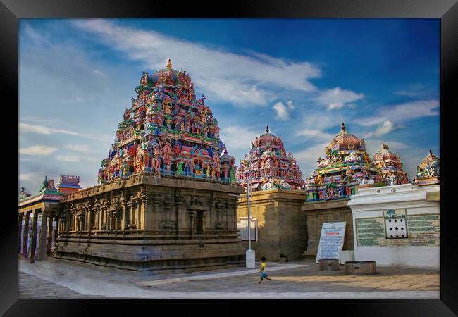 Chennai, India - October 27, 2018: Interior of Arulmigu Kapaleeswarar Temple an ancient Hindu architecture temple located in South India. A little Indian girl running inside a hindu temple Framed Print by Arpan Bhatia