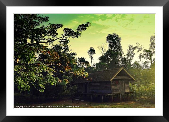 cabin house on the edge of the jungle Framed Mounted Print by John Lusikooy