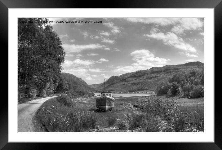 Boat near mountain road and lake in Scotland Framed Mounted Print by Philip Brown