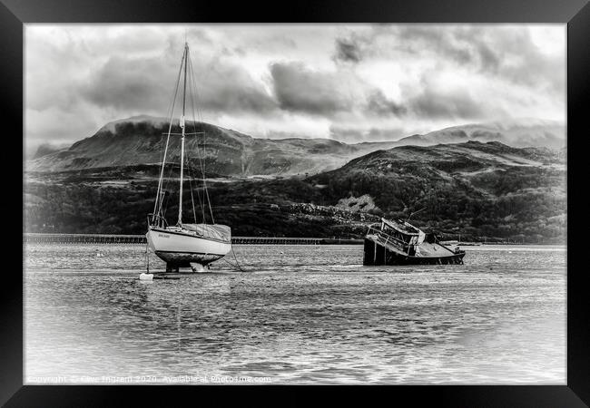 Boats at low tide with mountain backdrop Framed Print by Clive Ingram