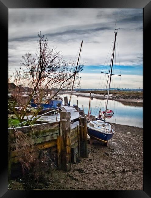 A mooring dock on the River Crouch with boats waiting for the tide. Hullbridge, Essex, UK. Framed Print by Peter Bolton
