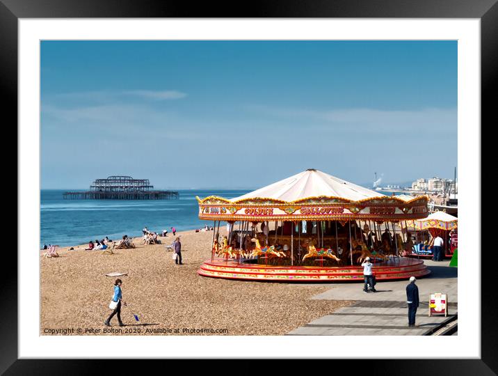 A merry-go-round on Brighton Beach on a summer day with West Pier ruins in the background. Sussex, UK. Framed Mounted Print by Peter Bolton