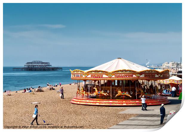 A merry-go-round on Brighton Beach on a summer day with West Pier ruins in the background. Sussex, UK. Print by Peter Bolton