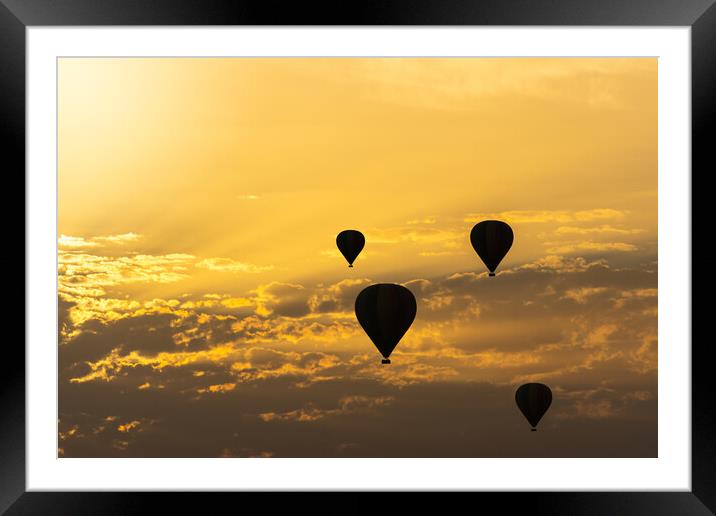 some hot air balloons in the sky with orange sunrise clouds Framed Mounted Print by David Galindo