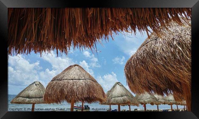 View of ocean through Sunshades at sandy beach in Mexico Framed Print by PhotOvation-Akshay Thaker
