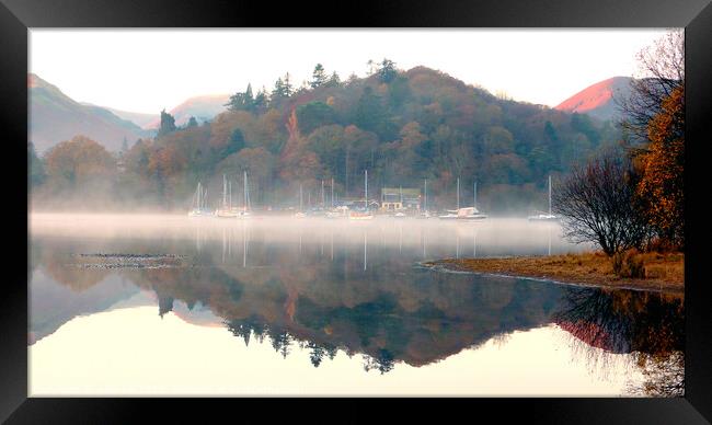 Yachts in the mist at Derwent Water in Cumbria. Framed Print by john hill
