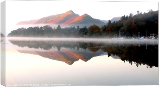 Morning reflections on Derwent water in Cumbria. Canvas Print by john hill