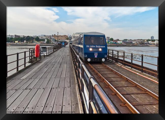 A train makes it way along the pier at Southend on Sea, Essex, UK Framed Print by Peter Bolton