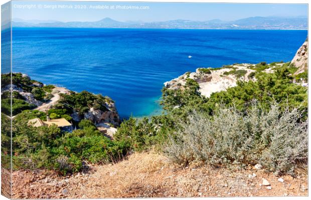 A hard, thorny shrub grows on the slope of the Gulf of Corinth against the backdrop of a blue lagoon on the coast. Canvas Print by Sergii Petruk