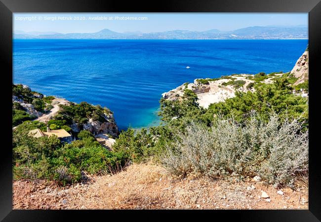 A hard, thorny shrub grows on the slope of the Gulf of Corinth against the backdrop of a blue lagoon on the coast. Framed Print by Sergii Petruk
