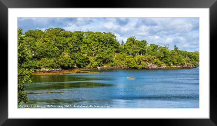 Canoe crossing sheltered bay in Loch Gairloch Framed Mounted Print by Angus McComiskey