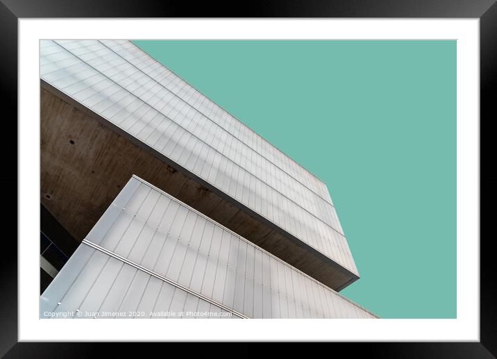 Low angle view of modern architecture glass facade against sky Framed Mounted Print by Juan Jimenez