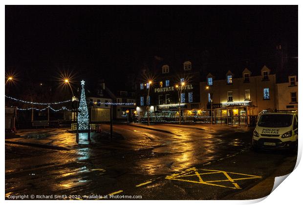 Somerled Square, Portree with Christmas tree and lights reflected on wet pavement Print by Richard Smith