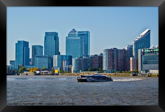 Canary Wharf Business District from the River Thames, London, UK. Framed Print by Peter Bolton
