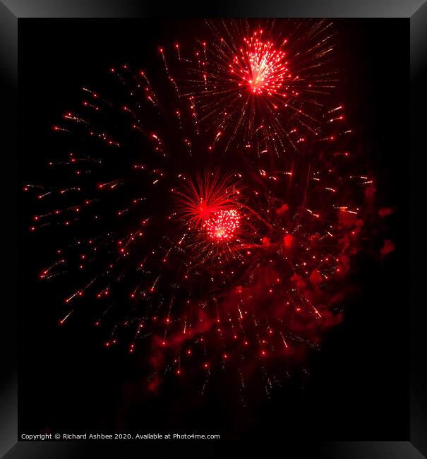 Red fireworks explode Framed Print by Richard Ashbee