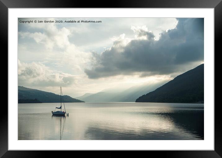 Solitary Boat on a tranquil Loch Tay Perthshire Scotland Framed Mounted Print by Iain Gordon
