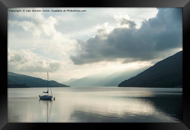 Solitary Boat on a tranquil Loch Tay Perthshire Scotland Framed Print by Iain Gordon