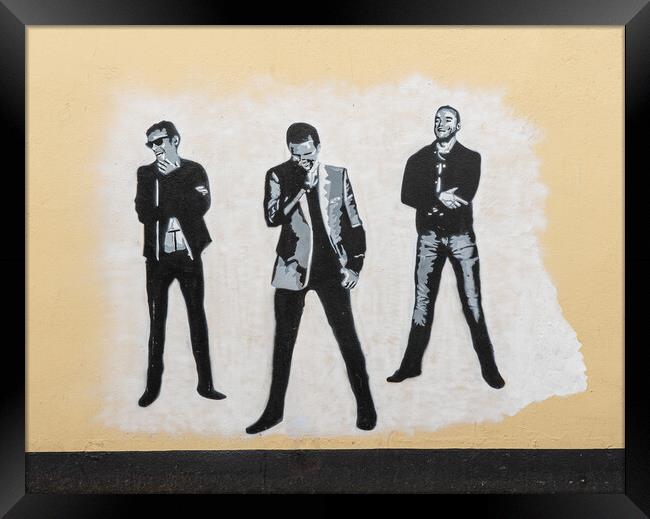 Wall painting of the pop group Muse  Framed Print by Steve Heap
